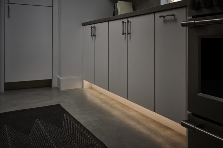 Lutron Lumaris tape light used as a toe light in a kitchen